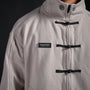 Tang Warmup Jacket in TWILIGHT bone, close-up of frog closures and chest patch | Village Hidden in Iron