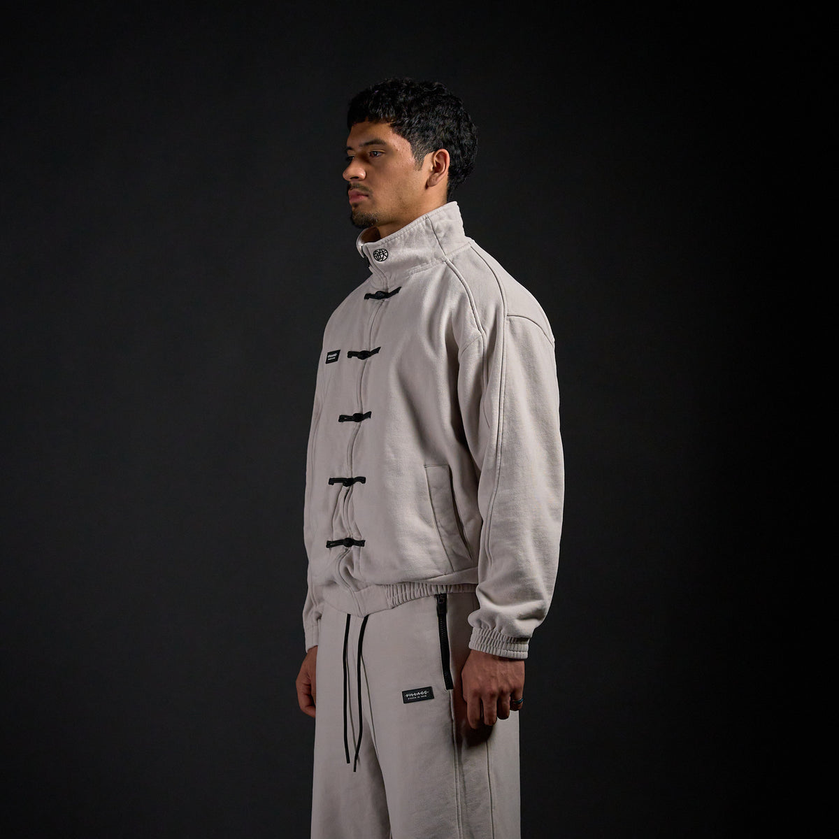 Tang Warmup Jacket in TWILIGHT bone, three-quarter view on model | Village Hidden in Iron