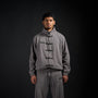 Tang Warmup Jacket in DARKSIDE charcoal grey, front view on model | Village Hidden in Iron