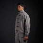 Tang Warmup Jacket in DARKSIDE charcoal grey, three-quarter view on model | Village Hidden in Iron