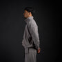 Tang Warmup Jacket in DARKSIDE charcoal grey, side view on model | Village Hidden in Iron