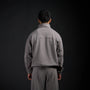 Tang Warmup Jacket in DARKSIDE charcoal grey, back view on model | Village Hidden in Iron