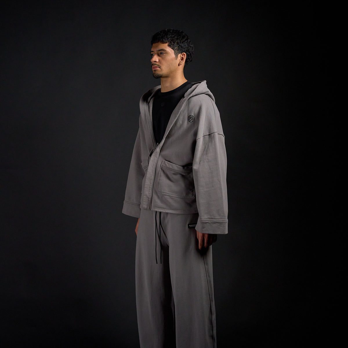 Haori Hoodie in DARKSIDE charcoal grey, three-quarter view on model | Village Hidden in Iron