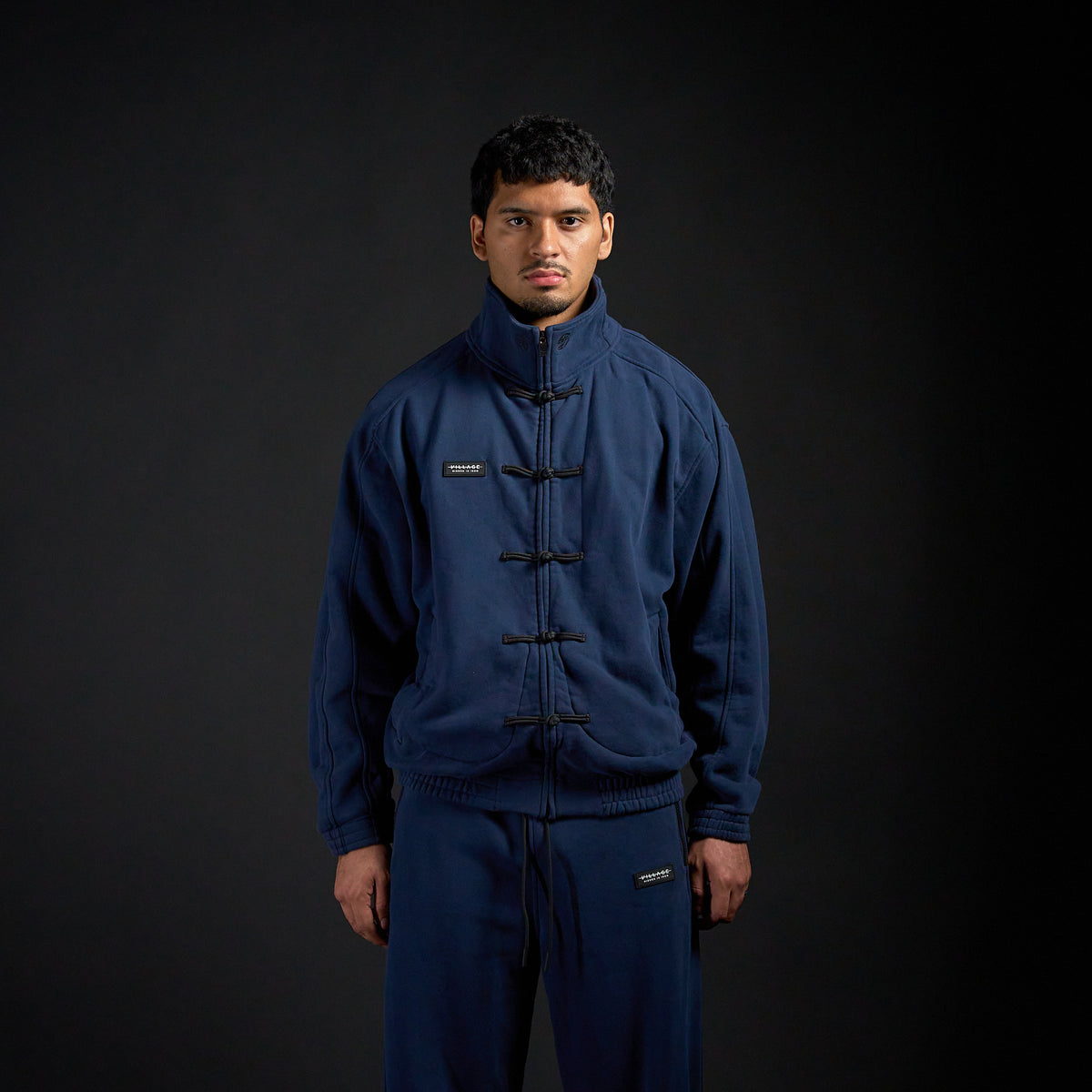 Tang Warmup Jacket in MIDNIGHT navy, front view on model | Village Hidden in Iron