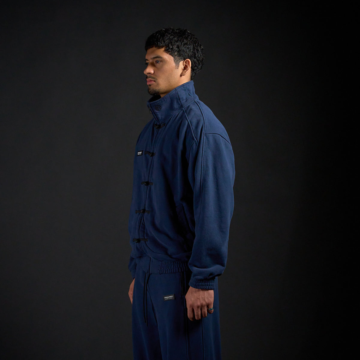 Tang Warmup Jacket in MIDNIGHT navy, three-quarter view on model | Village Hidden in Iron