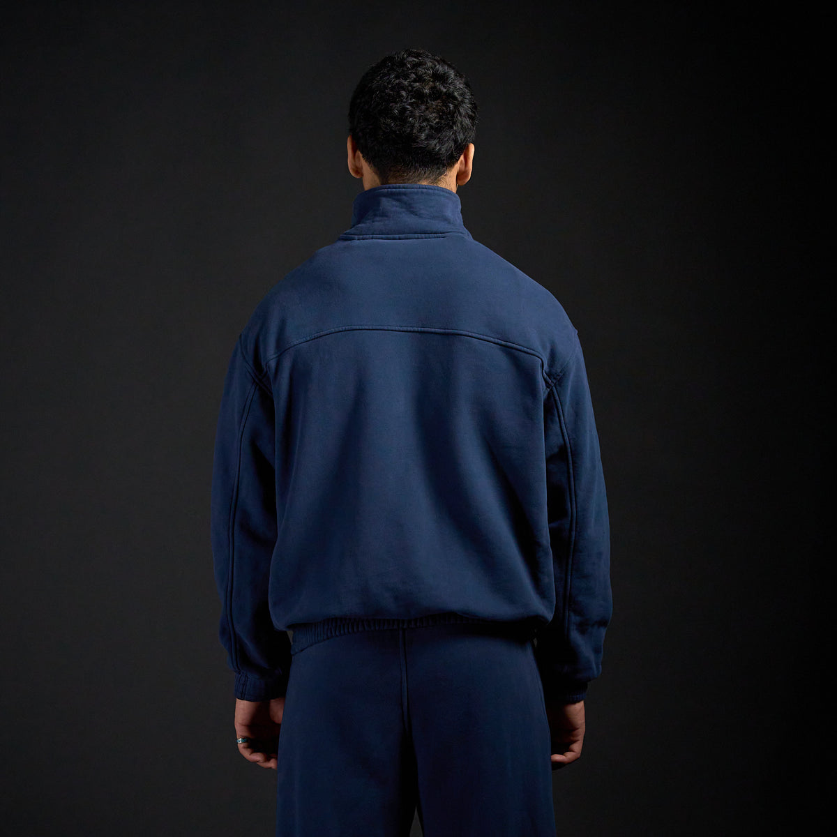 Tang Warmup Jacket in MIDNIGHT navy, back view on model | Village Hidden in Iron