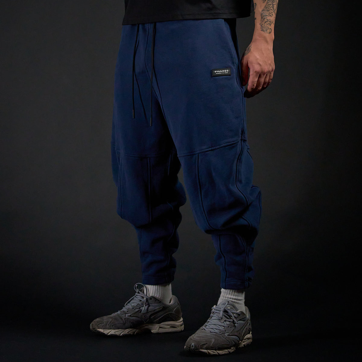 Tobi Sweatpants in MIDNIGHT navy, three-quarter view on model | Village Hidden in Iron