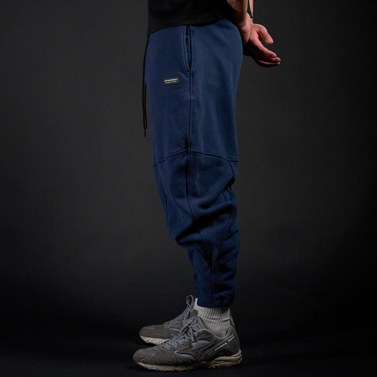Tobi Sweatpants in MIDNIGHT navy, side view on model | Village Hidden in Iron